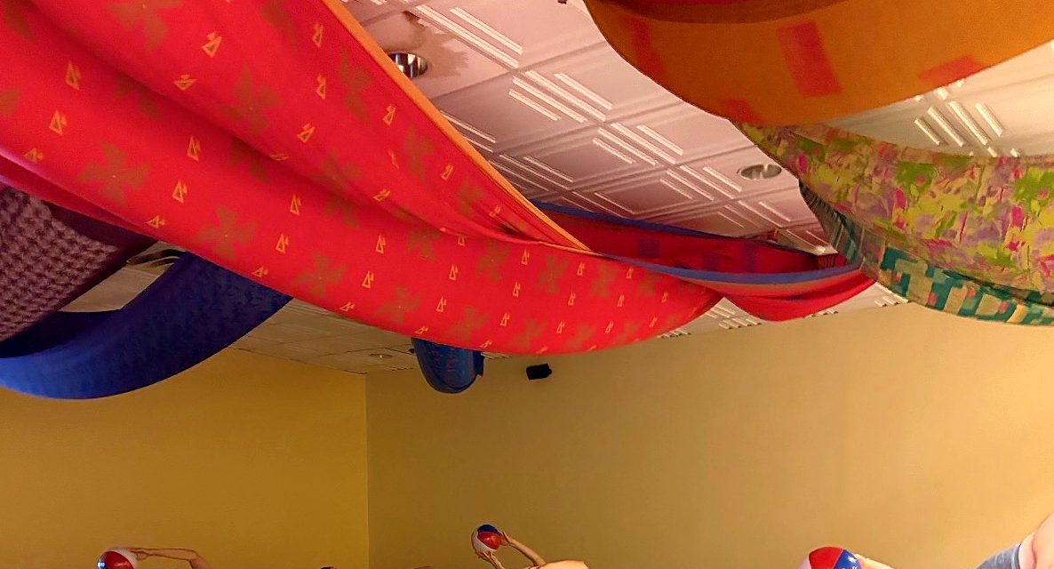 Red, orange and blue fabric draped across the studio ceiling