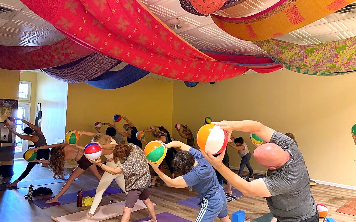 Students in a side stretch under the fabric ceiling